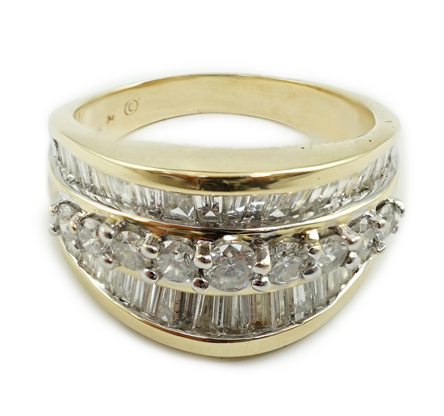 A modern 14k gold and three row baguette and round brilliant cut diamond set dress ring, based on the design of the Crown on the Statue of Liberty